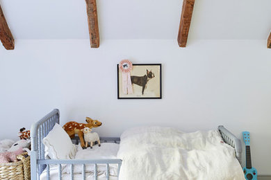 Example of a farmhouse white floor kids' bedroom design in New York with white walls