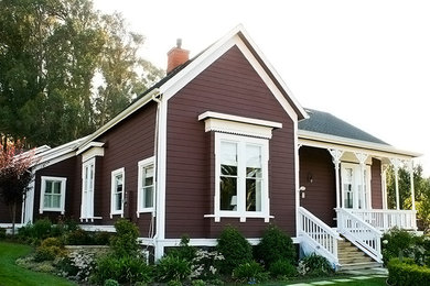 Photo of a large arts and crafts one-storey red exterior in San Luis Obispo with wood siding.