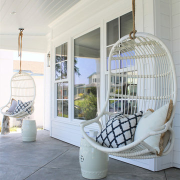 White Hanging Chairs on Coastal Front Porch