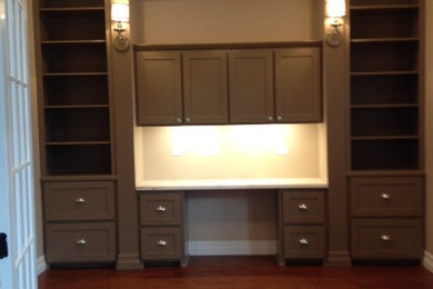 Example of a mid-sized transitional built-in desk dark wood floor and brown floor study room design in Austin with beige walls