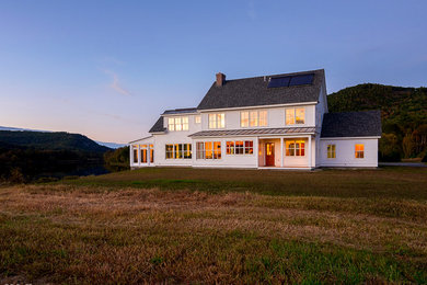 Country white two-story wood gable roof idea in Burlington