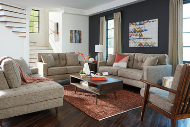 Inspiration for an eclectic dark wood floor and brown floor living room remodel in Houston with black walls and no fireplace