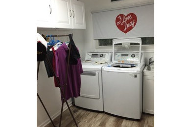 Mid-sized elegant laundry room photo in Chicago with white walls and a side-by-side washer/dryer