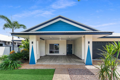 Large modern brick blue house exterior in Darwin with a gable roof, a metal roof and a white roof.