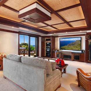 Design ideas for a large world-inspired enclosed home cinema in Hawaii with beige walls, carpet, a projector screen and beige floors.