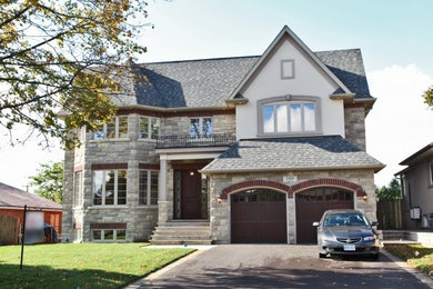 Mid-sized elegant gray three-story stone gable roof photo in Toronto