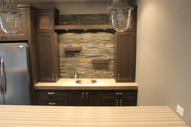 Mid-sized transitional galley dark wood floor and brown floor wet bar photo in Other with a drop-in sink, shaker cabinets, dark wood cabinets, wood countertops and stone tile backsplash