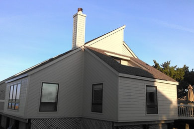 Example of a trendy concrete fiberboard exterior home design in Other