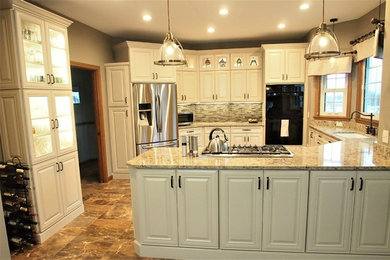 Kitchen - large traditional u-shaped porcelain tile and multicolored floor kitchen idea in Bridgeport with an integrated sink, raised-panel cabinets, beige cabinets, quartzite countertops, multicolored backsplash, stone tile backsplash, stainless steel appliances and a peninsula