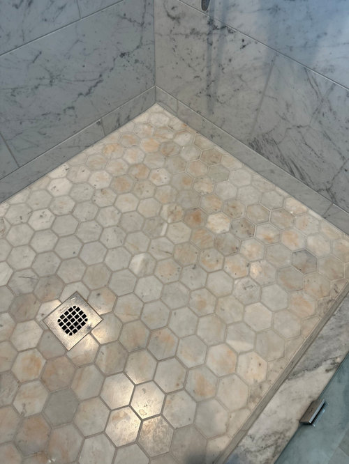 Could spray sunscreen discolor our marble shower floor? Coincidence?
