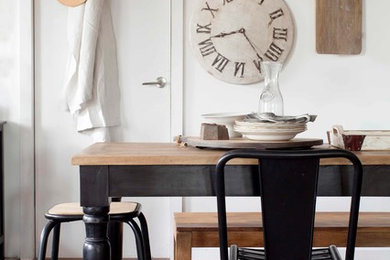 Industrial dining room in Melbourne with white walls.