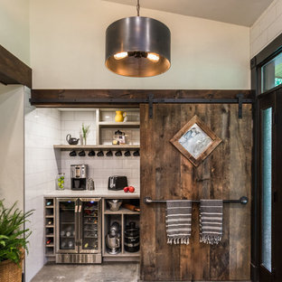 Неиссякаемый источник вдохновения для домашнего уюта: большая угловая кухня в стиле кантри с кладовкой, врезной раковиной, плоскими фасадами, черными фасадами, столешницей из кварцевого композита, белым фартуком, фартуком из керамогранитной плитки, техникой из нержавеющей стали, полом из цементной плитки, островом, серым полом и белой столешницей