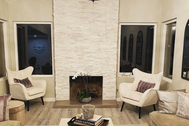 Inspiration for a mid-sized transitional formal and open concept brown floor and vaulted ceiling living room remodel in Los Angeles with beige walls, a standard fireplace, a tile fireplace and no tv