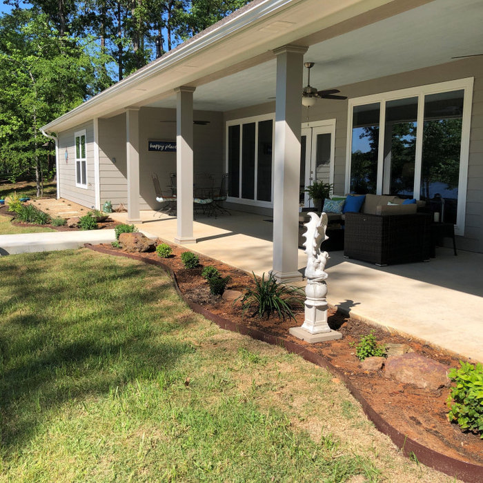 This is an example of a huge transitional concrete porch design in Dallas with a roof extension.