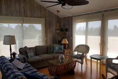 Inspiration for a large coastal open concept medium tone wood floor and brown floor family room remodel in Boston with brown walls