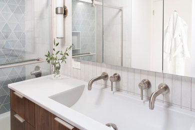 Example of a small 1960s master white tile and porcelain tile double-sink bathroom design in Chicago with flat-panel cabinets, medium tone wood cabinets, white walls, an integrated sink, solid surface countertops, white countertops and a freestanding vanity