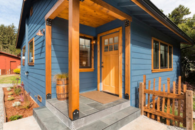 Inspiration for a small scandinavian tile front porch remodel in Other with a roof extension