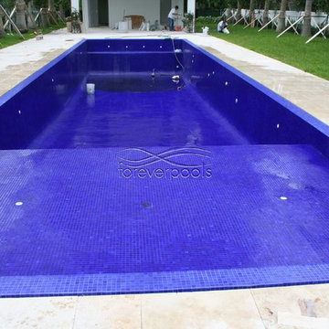 Infinity pool with solid dark blue glass tile