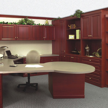 Traditional home office with extended round table with storage and many cabinets