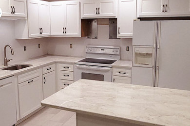 Example of a mid-sized trendy l-shaped eat-in kitchen design in Philadelphia with shaker cabinets, white cabinets, quartz countertops and an island