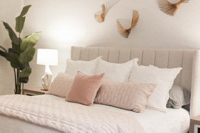 Example of a large transitional master medium tone wood floor, brown floor and tray ceiling bedroom design in Dallas with white walls