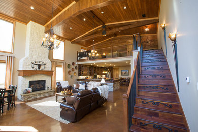 Inspiration for a large rustic open concept living room remodel in Dallas with white walls, a standard fireplace, a stone fireplace and no tv