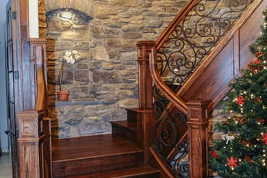 Example of a large classic wooden curved staircase design in Other with wooden risers