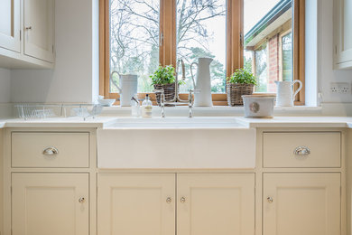Design ideas for a small country u-shaped utility room in Hertfordshire with a farmhouse sink, beaded inset cabinets, grey cabinets, quartzite benchtops, grey walls, ceramic floors, a side-by-side washer and dryer, beige floor and white benchtop.