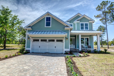 Inspiration for a mid-sized coastal green two-story concrete fiberboard gable roof remodel in Baltimore