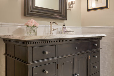 Bathroom - traditional 3/4 white tile bathroom idea in Seattle with furniture-like cabinets, dark wood cabinets and marble countertops