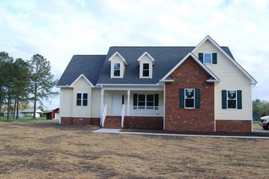 Inspiration for a large yellow two-story mixed siding exterior home remodel in Richmond