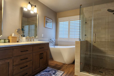 Bathroom - contemporary beige tile and porcelain tile porcelain tile, brown floor and double-sink bathroom idea in Los Angeles with shaker cabinets, medium tone wood cabinets, beige walls, an undermount sink, quartz countertops, a hinged shower door, white countertops and a built-in vanity