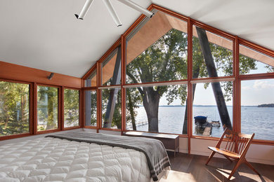 Design ideas for a country master bedroom in Minneapolis with brown floor, white walls and medium hardwood floors.