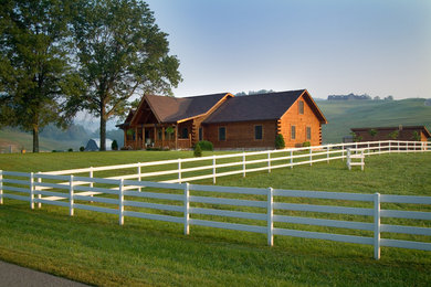 Inspiration for a large rustic brown one-story wood gable roof remodel in Huntington