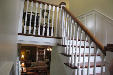 Elegant wooden u-shaped staircase photo in Atlanta with painted risers