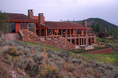 Large rustic brown two-story mixed siding gable roof idea in Jackson