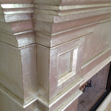 Fireplace makeover, dark wood "before", silver leaf "after"
