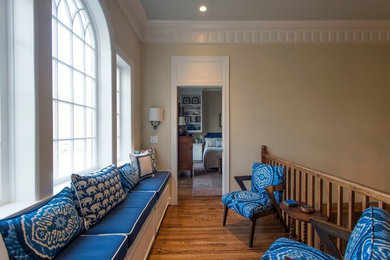 Transitional medium tone wood floor and brown floor hallway photo in Nashville with beige walls