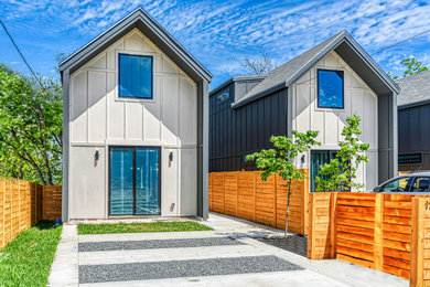 Example of a small trendy multicolored two-story concrete fiberboard exterior home design in Other with a mixed material roof