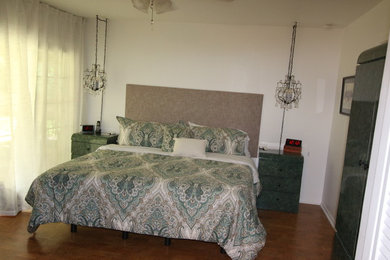 Example of a mid-sized classic master porcelain tile and brown floor bedroom design in Austin with white walls and no fireplace