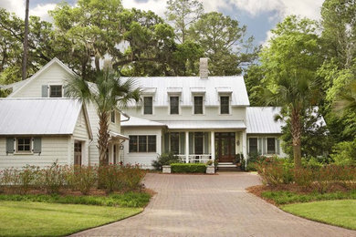 Inspiration for a mid-sized traditional two-storey white exterior in Charleston with wood siding.