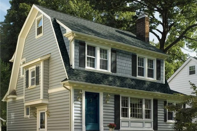 Example of a mid-sized classic gray two-story mixed siding house exterior design in Chicago with a gambrel roof and a shingle roof
