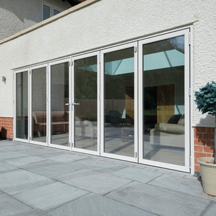 This is an example of a large and multi-coloured modern two floor detached house in Other with a hip roof, a mixed material roof and mixed cladding.