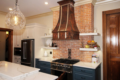 Example of a large classic l-shaped vinyl floor and brown floor enclosed kitchen design in New York with a farmhouse sink, raised-panel cabinets, blue cabinets, quartz countertops, white backsplash, subway tile backsplash, stainless steel appliances, an island and white countertops