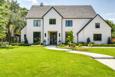 Transitional two-storey white house exterior in Dallas with a gable roof and a shingle roof.