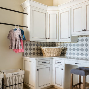 This is an example of a mediterranean l-shaped separated utility room in San Luis Obispo with recessed-panel cabinets, marble worktops, beige walls and white cabinets.