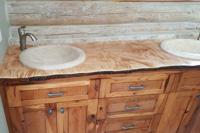 Drop-in bathtub - mid-sized craftsman 3/4 concrete floor drop-in bathtub idea in Boise with shaker cabinets, medium tone wood cabinets, beige walls, a drop-in sink and wood countertops