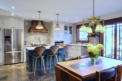 Inspiration for a mid-sized craftsman l-shaped slate floor and multicolored floor eat-in kitchen remodel in Calgary with an undermount sink, shaker cabinets, gray cabinets, quartz countertops, gray backsplash, ceramic backsplash, stainless steel appliances and an island