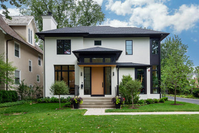 Example of a large minimalist white two-story stucco house exterior design in Chicago with a shingle roof and a black roof