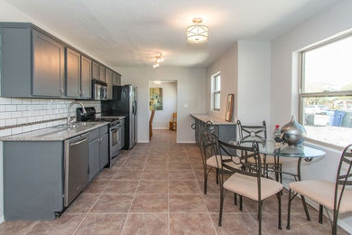 Inspiration for a mid-sized contemporary porcelain tile and beige floor eat-in kitchen remodel in Phoenix with granite countertops, white backsplash, ceramic backsplash, a drop-in sink, shaker cabinets, gray cabinets, stainless steel appliances and no island